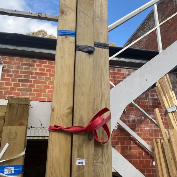 Three bundles of 9ft timber secured with a red strap.