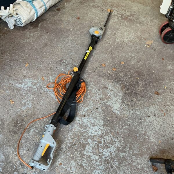 Titan electric pole trimmer with long black shaft and grey cutting head
