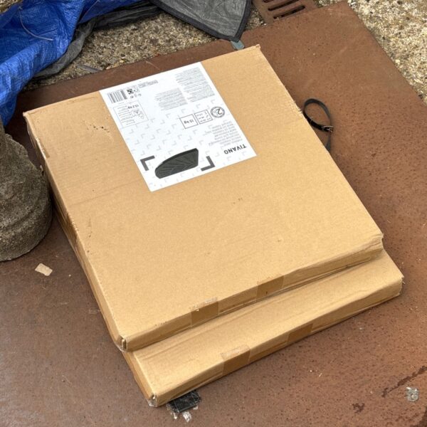 Tivano garden parasol in damaged packaging, ready for restoration.