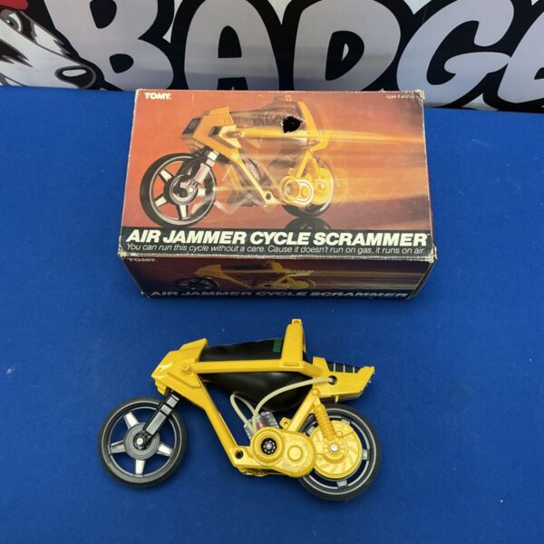 Vintage Tomy Air Jammer Cycle Scrammer toy in yellow.