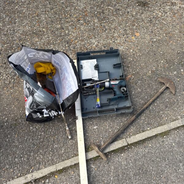 Tool lot including Bosch drill, spirit level and garden tools.