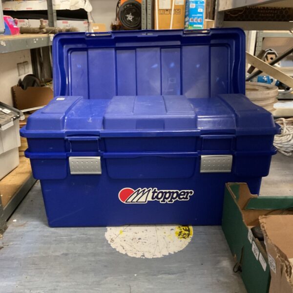 Blue Topper storage box with hinged lid, showing signs of wear.