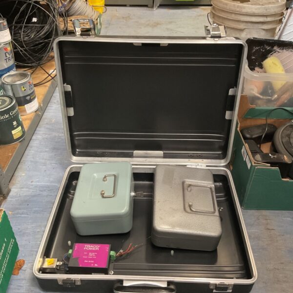 Traco Power DC/DC converter with two lockable cash boxes in open black flight case