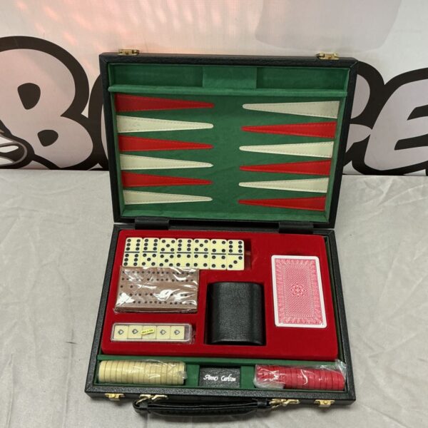 Open black travel games set with backgammon board, dominoes, cards and poker dice