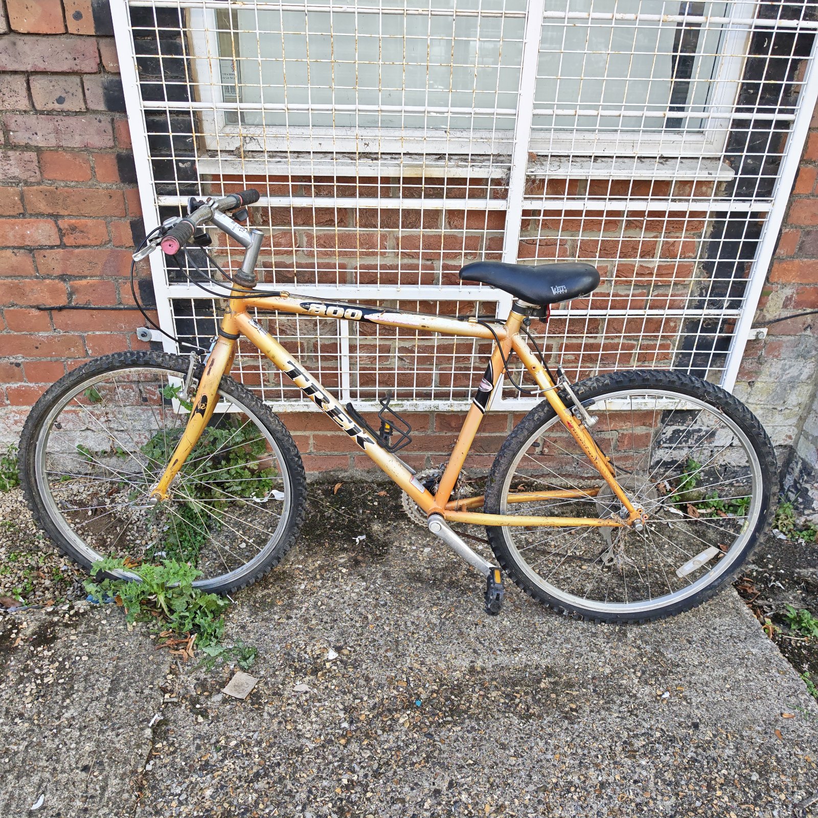 Vintage Trek 800 mountain bike in orange, side view.