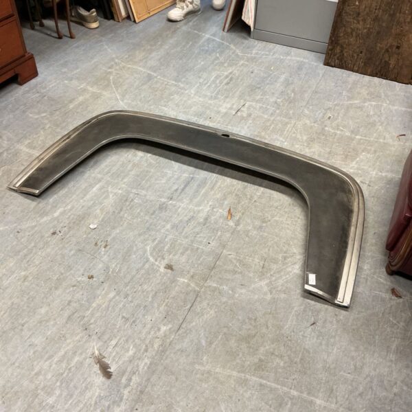 Curved Triumph Stag folding roof cover panel with metal edge trim on floor