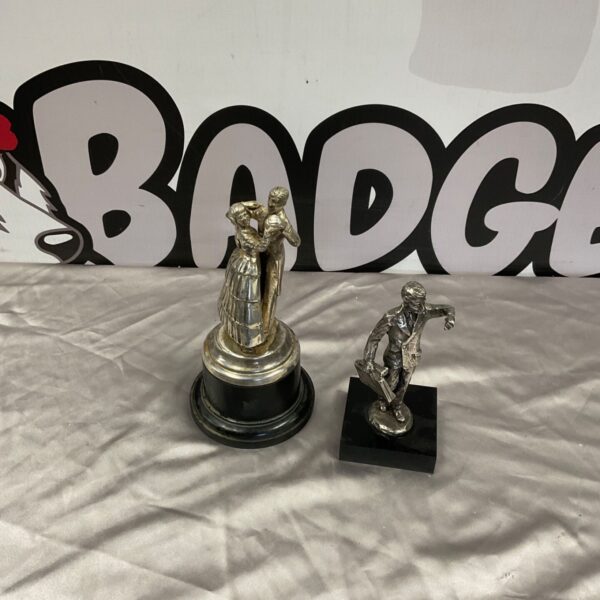 Two metal figures, dancing couple on black circular base and standing man