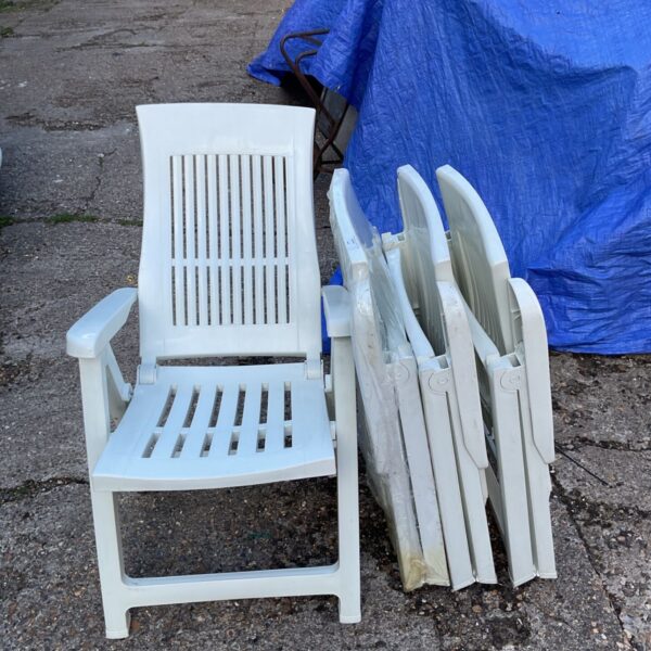 Four URBNLIVING folding garden loungers in a garden setting.