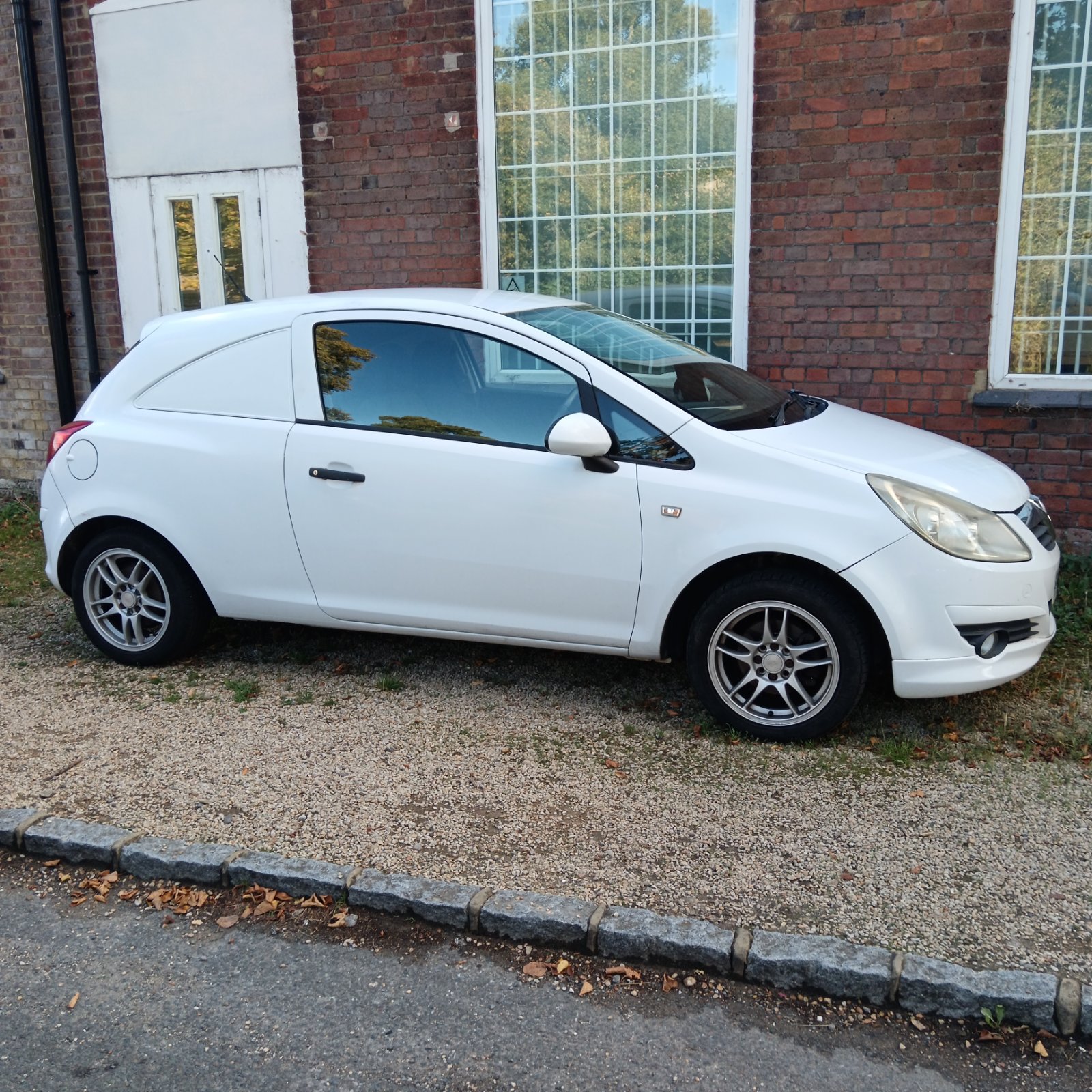 White Vauxhall Corsa Eco Flex van parked on gravel.