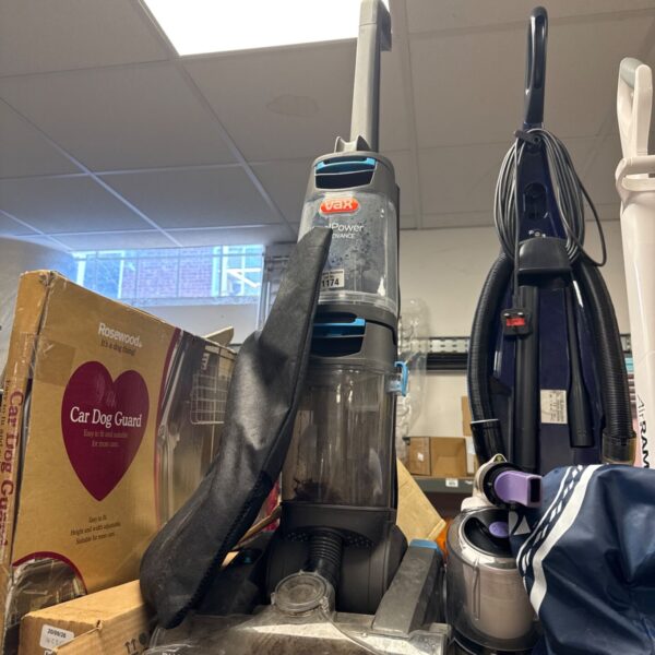 Front view of a Vax carpet cleaner with accessories.