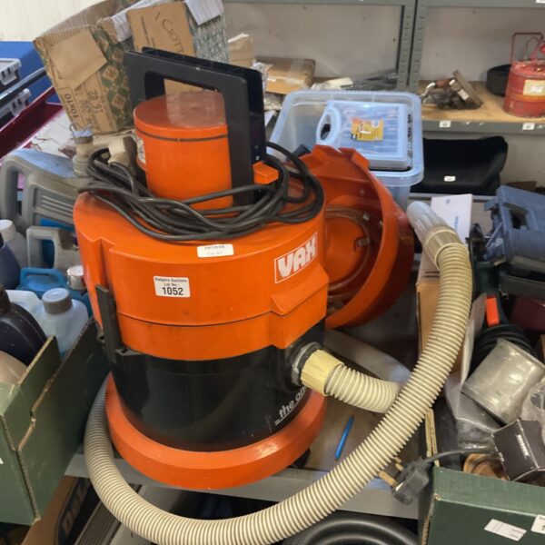 Vintage orange Vax model 121 wet and dry vacuum cleaner with grey hose