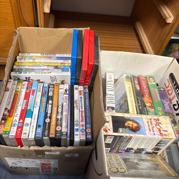 Mixed lot of VHS tapes and DVDs for film collection.