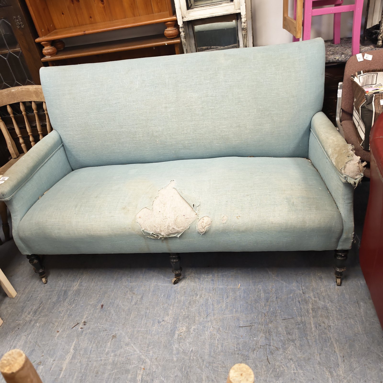 Antique Victorian baby blue sofa needing reupholstering.