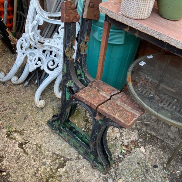 Antique Victorian cast iron bench ends with floral detailing for garden seating.
