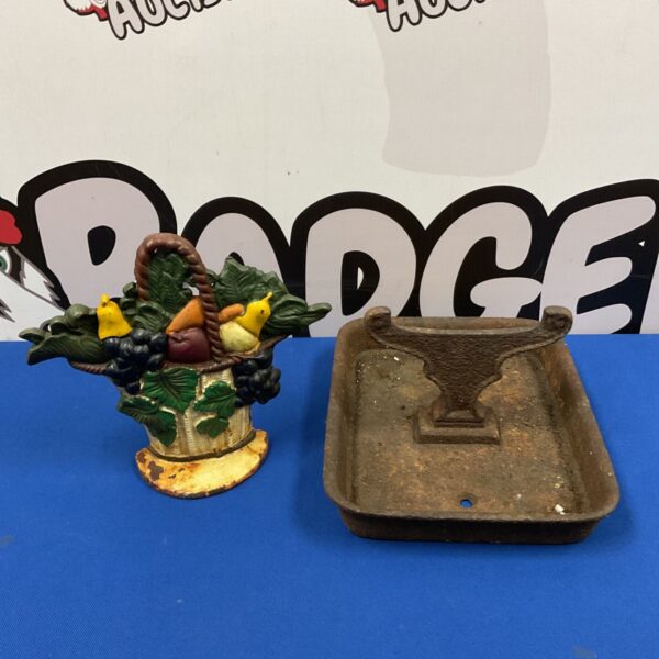 Victorian cast iron doorstop with a colourful flower basket.
