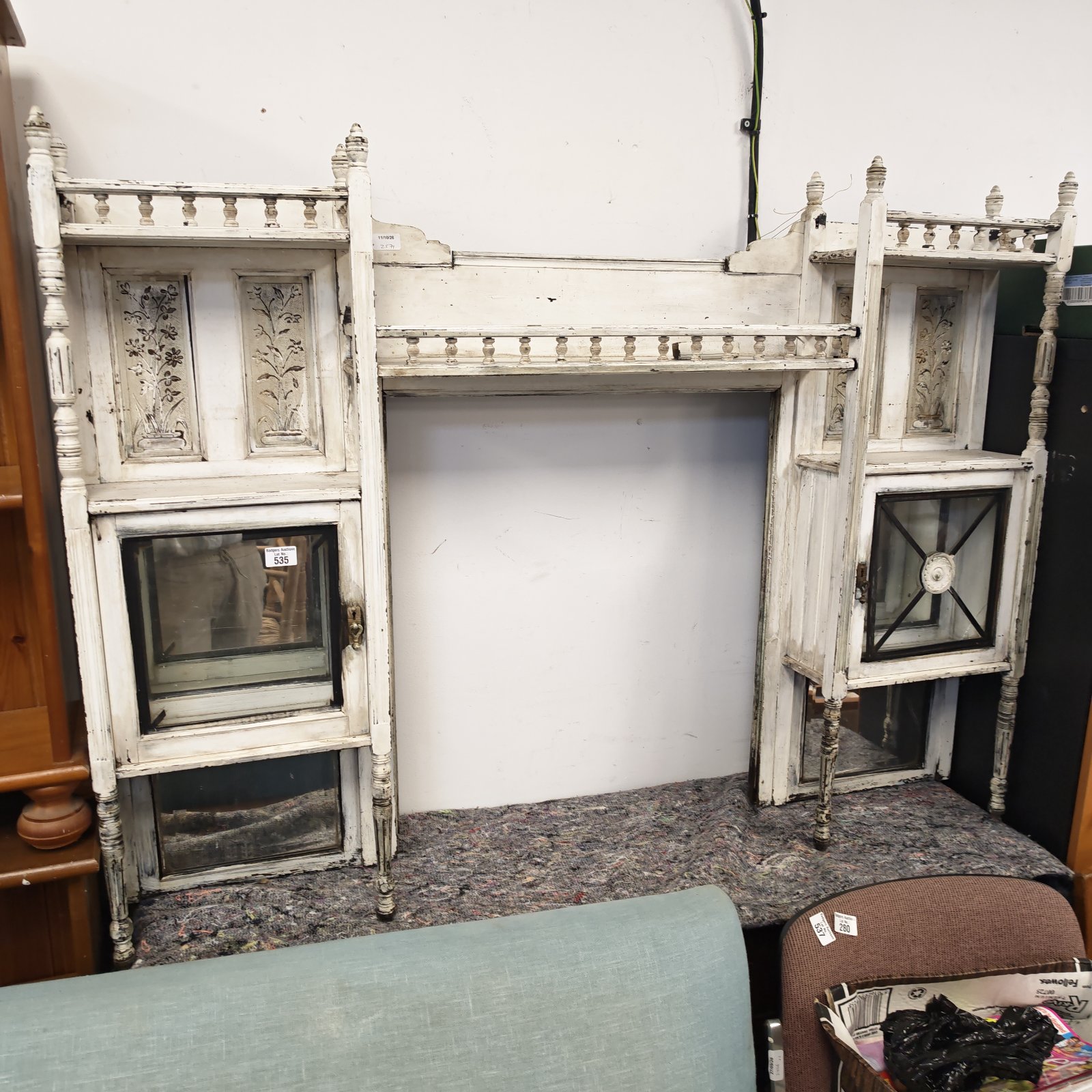 Antique Victorian dresser top with floral carvings and glass cabinets.