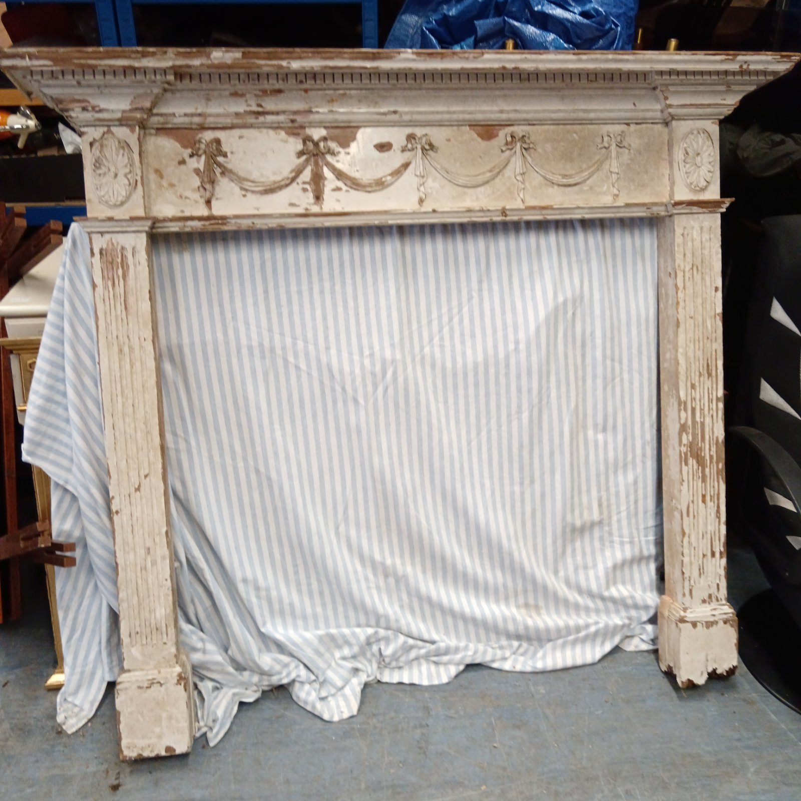 Antique Victorian fireplace surround with floral details.