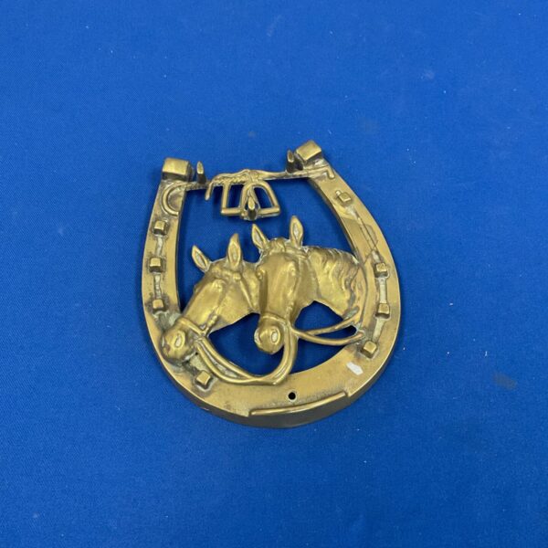 Antique Victorian horse brass plaque with detailed horse head carving.