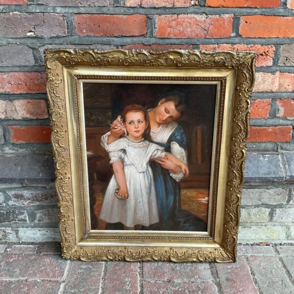 Victorian oil painting of a mother and child in a gilt frame.