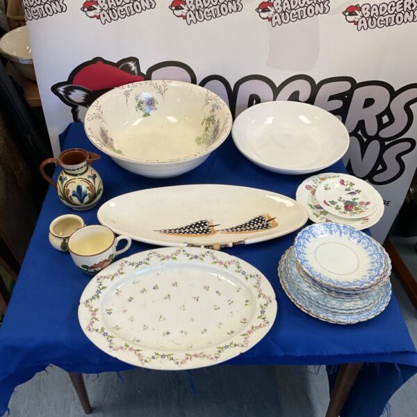 Antique porcelain wash bowl with floral pattern and matching tableware.