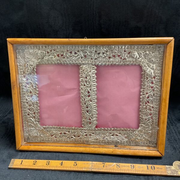 Ornate Victorian silver double picture frame with glazed case.