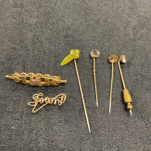 Victorian jewellery collection featuring citrine and jade stick pins and brooches.