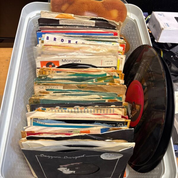 Basket of vintage 45rpm vinyl singles in paper sleeves, 1960s rock and pop