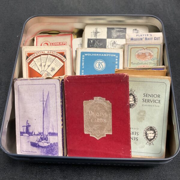 Vintage advertising playing cards in a tin, featuring brands like Prudential.
