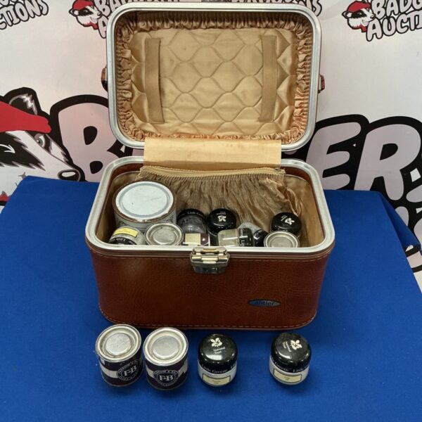 Vintage Antler suitcase open with a collection of miniature paint pots inside.