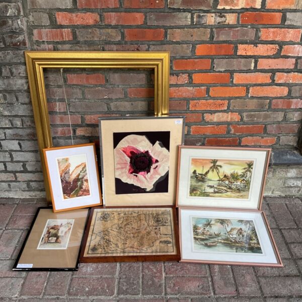 Vintage art collection featuring framed botanical print and gilt frame.