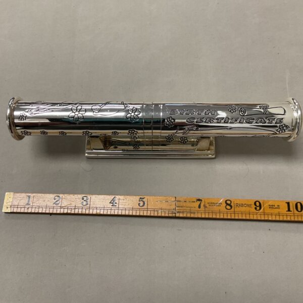 Vintage silver-plated baby birth certificate holder with floral design.