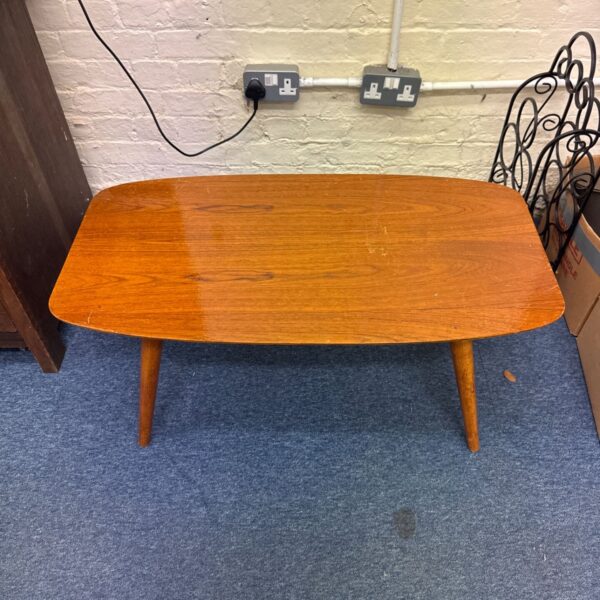 Vintage Beautility coffee table with shaped wood veneer top and tapering legs