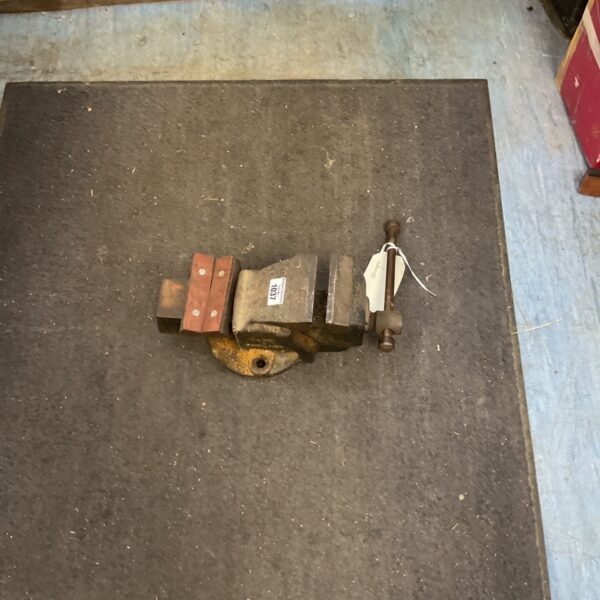 Vintage cast iron bench vice for metalworking and workshop use.