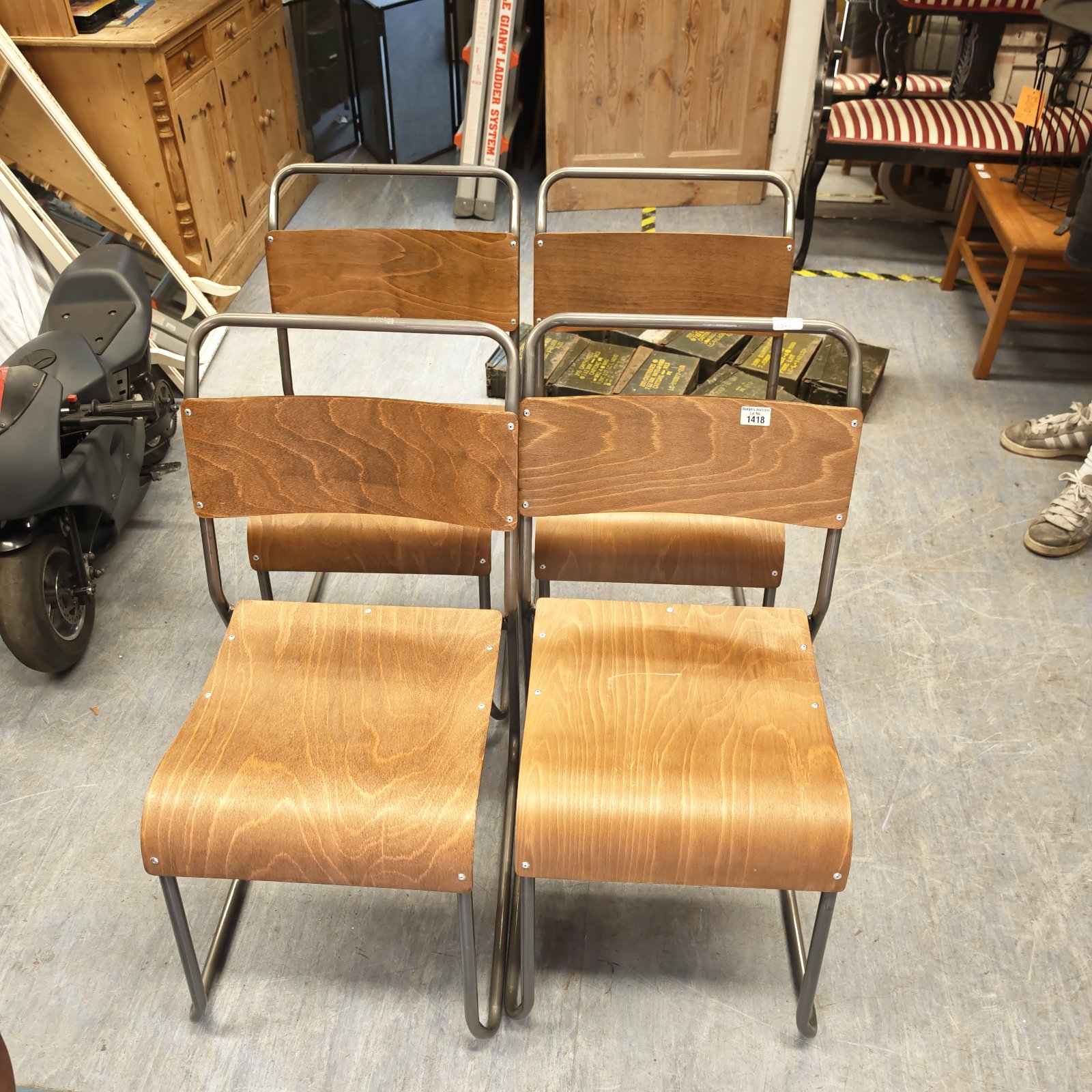Four vintage bentwood chairs with metal frames in a room setting.