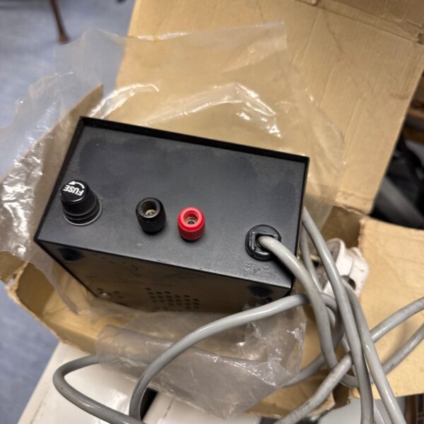 Vintage Bermec 13.8v DC power supply with red and black terminals.
