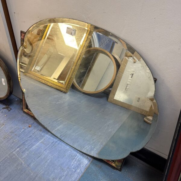 Vintage bevelled edge mirror with ornate gilded frame.