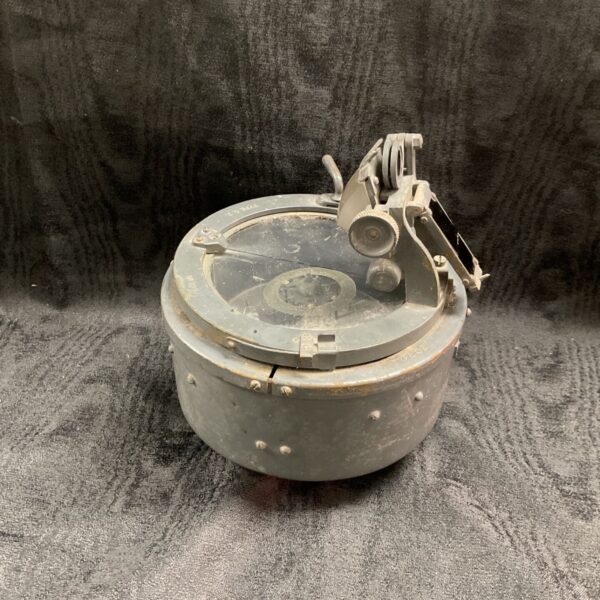 Vintage boat compass with fluid-filled capsule and metal housing.