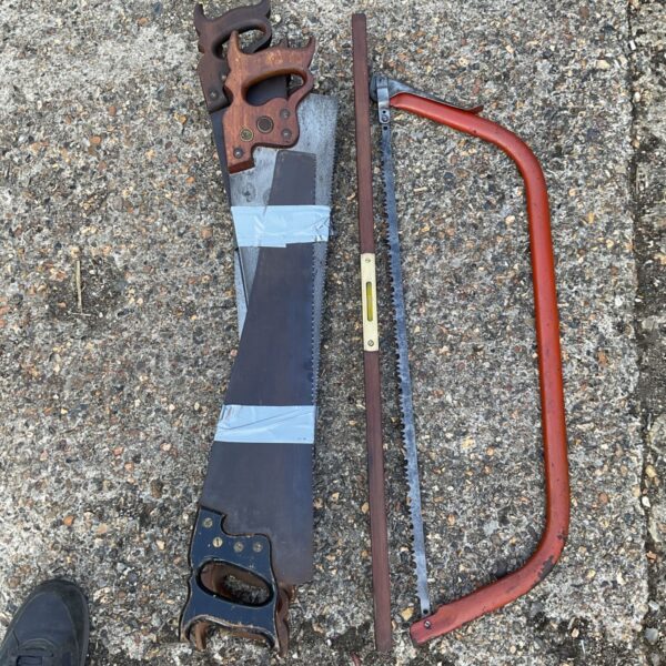 Vintage bow saw with wooden handle and steel frame.