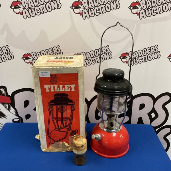 Red vintage Tilley X246B Stormlight lamp beside its original box
