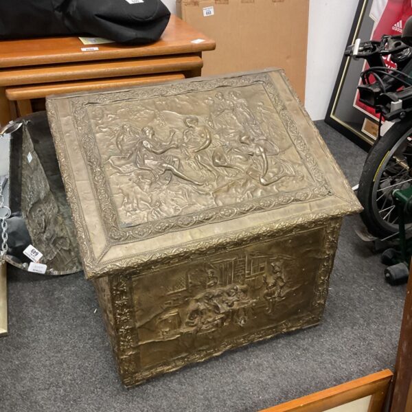 Vintage brass coal box with classical figure design.