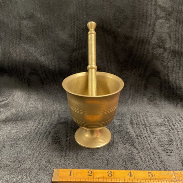 Vintage brass mortar and pestle with pedestal foot and banded decoration