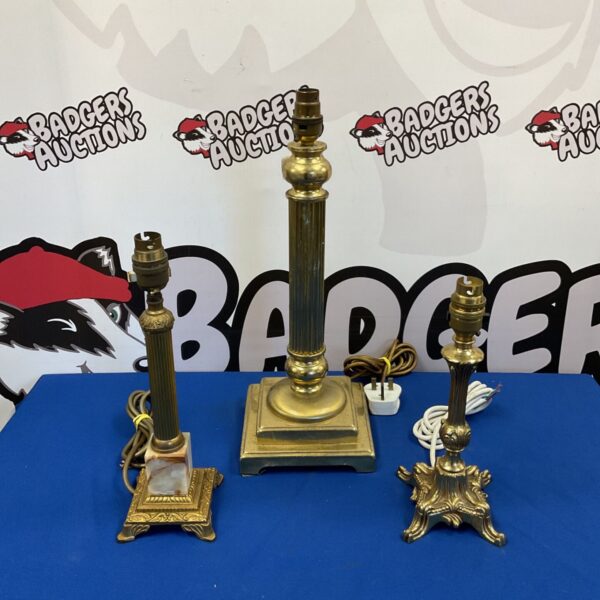 Set of three vintage brass table lamps with cream shades.
