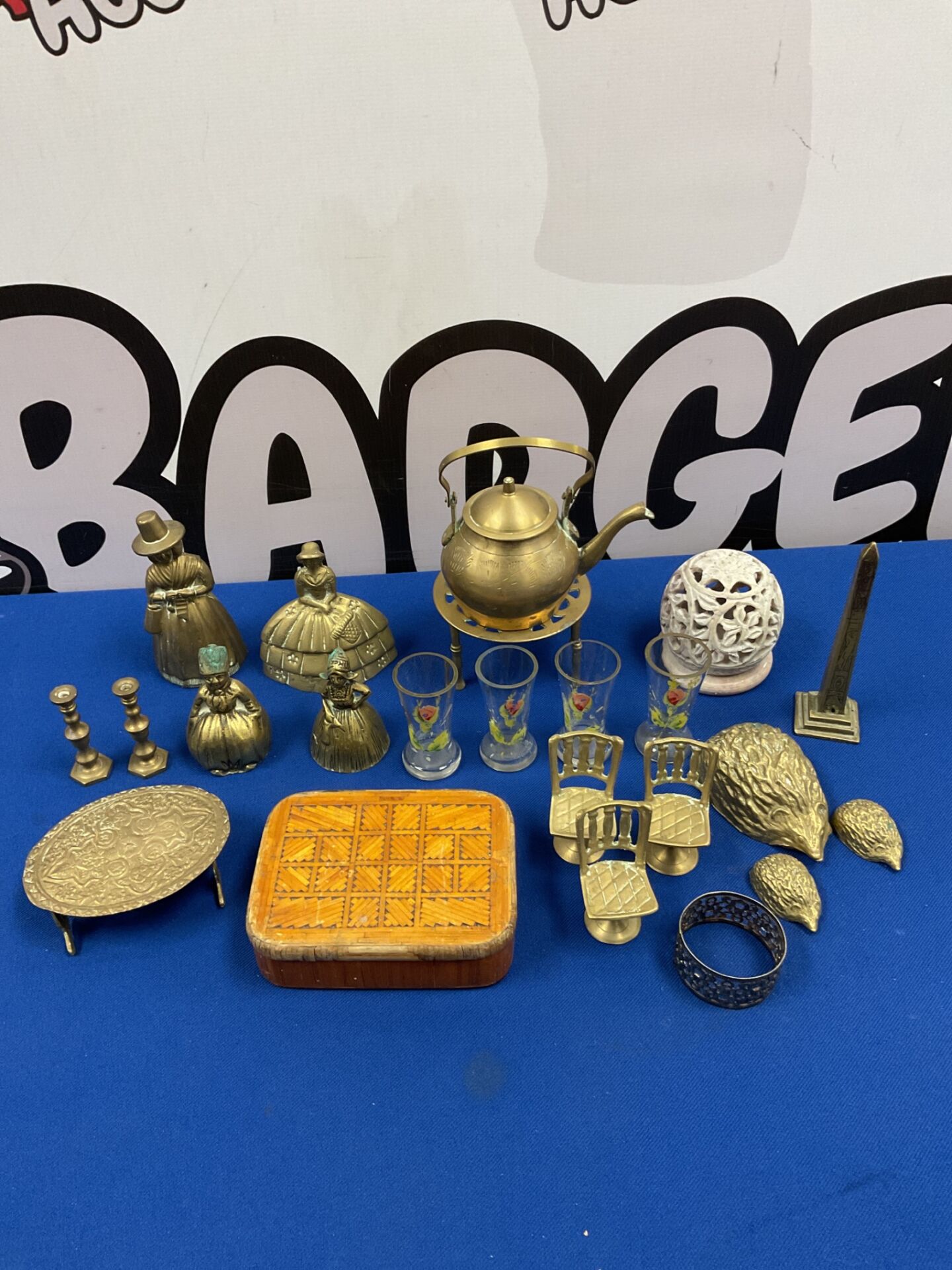 056 Selection of brassware including bells, hedgehogs & miniature candlesticks