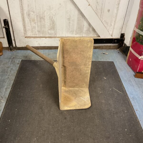 Vintage bricklayer bickhod with wooden handle, a classic masonry tool.