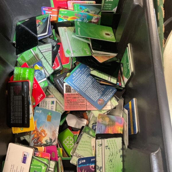 Large mixed lot of vintage BT phone cards in a black plastic tub
