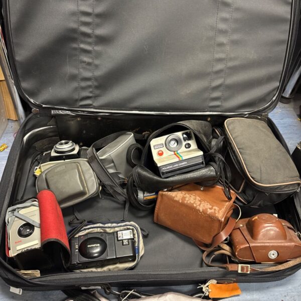 Vintage camera lot including Kodak and Olympus cameras in a case.