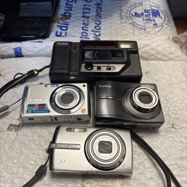 Vintage cameras lot including Kodak, Olympus, and Panasonic models.