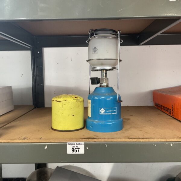 Vintage blue Campingaz Lumogaz T 206 gas lantern beside yellow spare canister