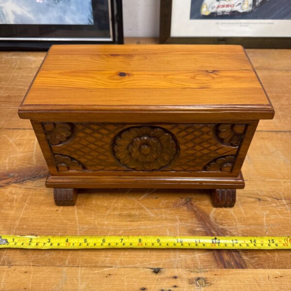 Vintage carved wood box with floral details, antique storage solution.