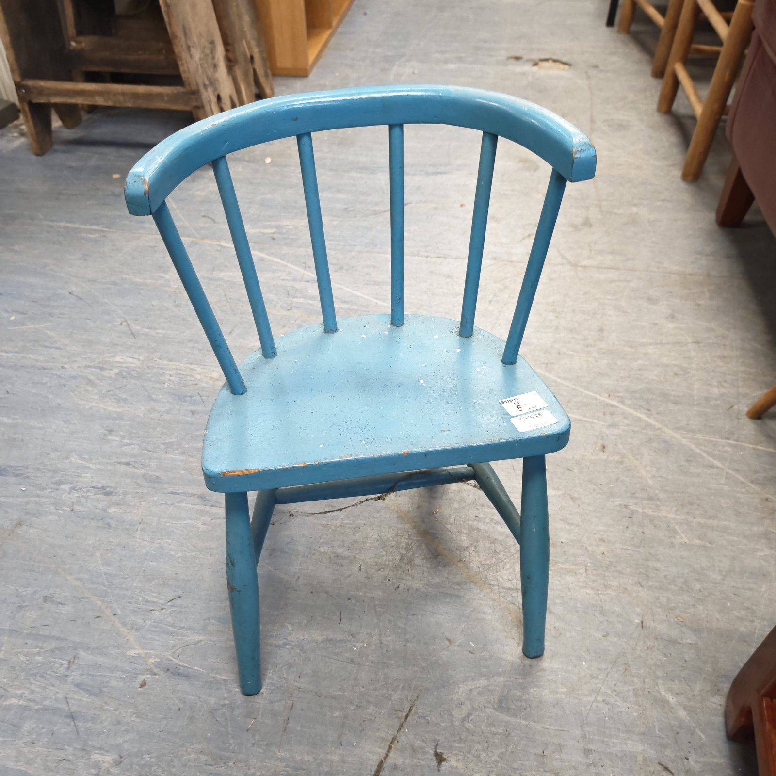 Blue vintage child's chair with spindle back.